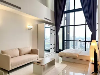 a living room with a couch and a bed at [M City Duplex Studio] Stunning High Floor View! in Kuala Lumpur