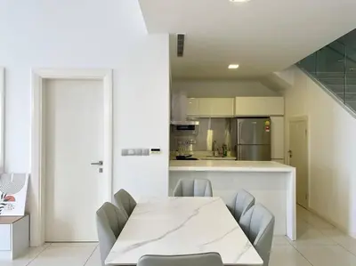 a kitchen with a white table and chairs in it at [M City Duplex Studio] Stunning High Floor View! in Kuala Lumpur