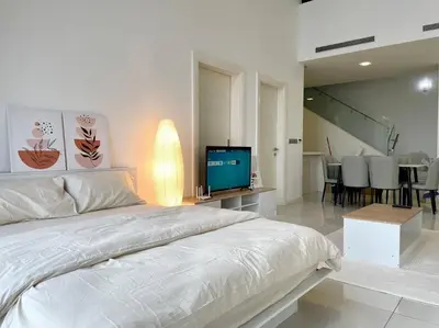 a white bedroom with a bed and a television at [M City Duplex Studio] Stunning High Floor View! in Kuala Lumpur