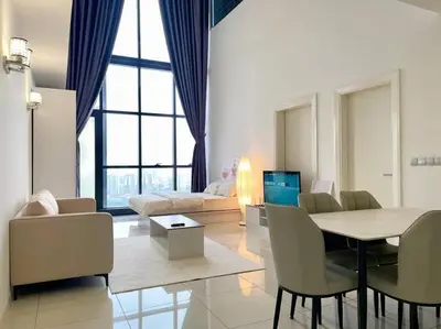 a living room with a table and chairs and a couch at [M City Duplex Studio] Stunning High Floor View! in Kuala Lumpur