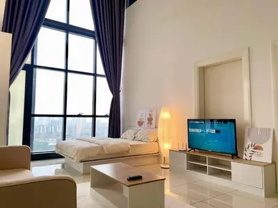 a living room with a bed and a television at [M City Duplex Studio] Stunning High Floor View! in Kuala Lumpur