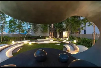 a view of a garden with benches and a building at scatletz suites klcc by yatie in Kuala Lumpur