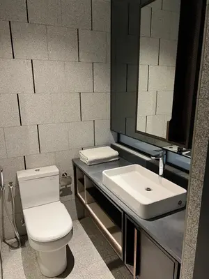 a bathroom with a white toilet and a sink at scatletz suites klcc by yatie in Kuala Lumpur