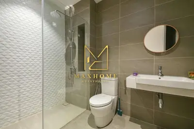 a bathroom with a toilet and a sink and a mirror at Maxhome Premium at Quill Residence KL City Centre in Kuala Lumpur