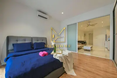 a bedroom with a large blue bed and a living room at Maxhome Premium at Quill Residence KL City Centre in Kuala Lumpur