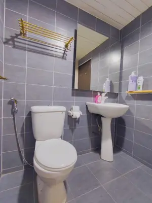 a bathroom with a toilet and a sink at Fahrenheit88 2minsPavilionKL TRX by Abby Stay in Kuala Lumpur