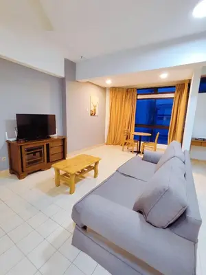 a living room with a couch and a flat screen tv at Fahrenheit88 2minsPavilionKL TRX by Abby Stay in Kuala Lumpur