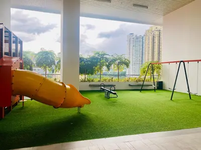 a play room with a slide and swings at Chambers Residences ZFJ World in Kuala Lumpur