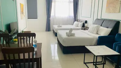 a hotel room with two beds and a couch at Chambers Residences ZFJ World in Kuala Lumpur