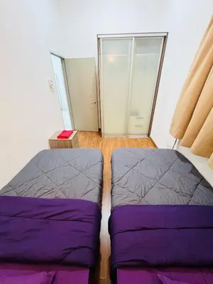 two beds in a room with glass doors at klcc view VUE residences Hkl 2 in Kuala Lumpur