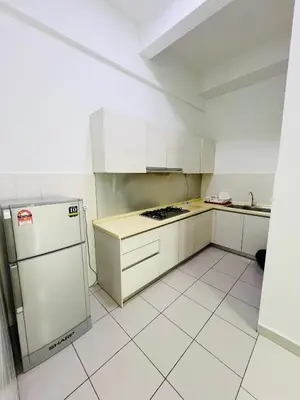 a white kitchen with a stove and a refrigerator at klcc view VUE residences Hkl 2 in Kuala Lumpur