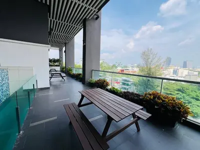 a balcony with a wooden bench on top of a building at klcc view VUE residences Hkl 2 in Kuala Lumpur