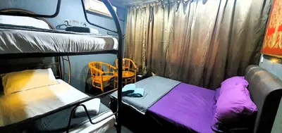 a room with two bunk beds in a bus at Guesthouse@ Bukit Bintang in Kuala Lumpur