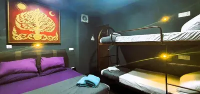 a room with two bunk beds and a painting on the wall at Guesthouse@ Bukit Bintang in Kuala Lumpur