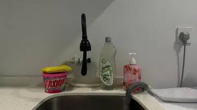 a kitchen counter with a sink and a bottle of detergent at Cozy Studio Kuala Lumpur by LH in Kuala Lumpur