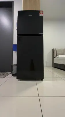 a black refrigerator sitting on top of a white floor at Cozy Studio Kuala Lumpur by LH in Kuala Lumpur