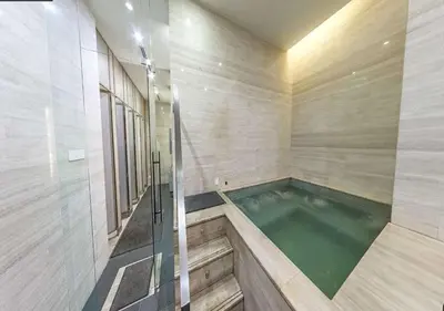 a swimming pool in a bathroom with a tub at Sfera Residence Kuala Lumpur City Centre in Kuala Lumpur