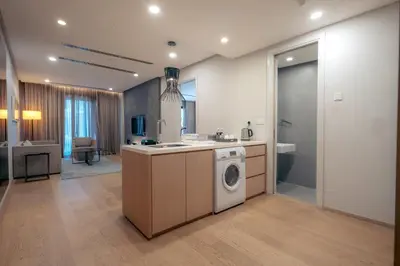 a kitchen with a washer and a washing machine at Sfera Residence Kuala Lumpur City Centre in Kuala Lumpur