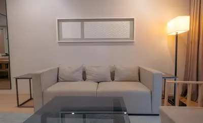 a living room with a couch and a table at Sfera Residence Kuala Lumpur City Centre in Kuala Lumpur
