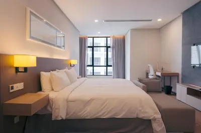 a hotel room with a large bed and a window at Sfera Residence Kuala Lumpur City Centre in Kuala Lumpur