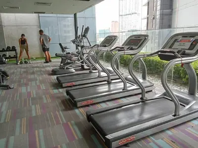 a row of cardio machines in a gym at Diamond Suite KL at Mercu Summer Suite KLCC in Kuala Lumpur