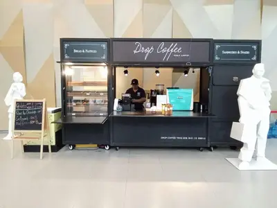 a food cart with a person sitting at a counter at Diamond Suite KL at Mercu Summer Suite KLCC in Kuala Lumpur
