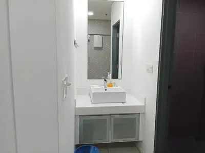 a bathroom with a white sink and a mirror at Diamond Suite KL at Mercu Summer Suite KLCC in Kuala Lumpur