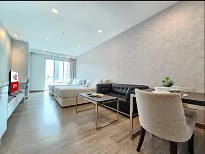 a living room with a couch and a bed and a table at KL City Suites 2-4pax near KLCC & Bukit Bintang in Kuala Lumpur