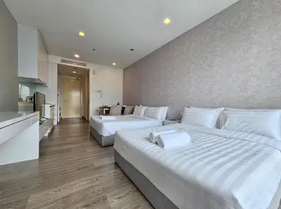 two beds in a large room with a kitchen at KL City Suites 2-4pax near KLCC & Bukit Bintang in Kuala Lumpur