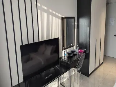 a living room with a large flat screen tv at Axon Residence Kuala Lumpur Pavilion in Kuala Lumpur