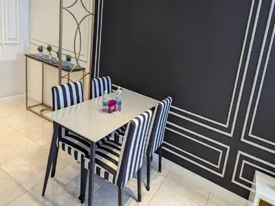 a dining room with a table and two chairs at Axon Residence Kuala Lumpur Pavilion in Kuala Lumpur