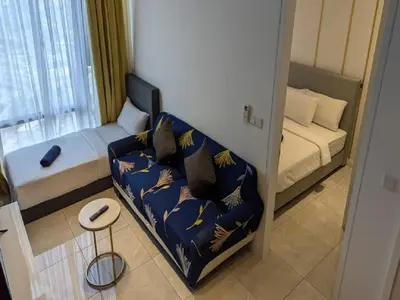 a small room with a couch and a bed at Axon Residence Kuala Lumpur Pavilion in Kuala Lumpur