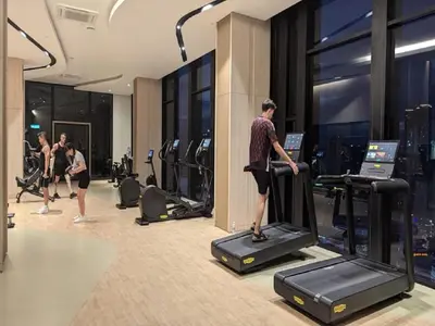 a group of people exercising in a gym at Axon Residence Kuala Lumpur Pavilion in Kuala Lumpur