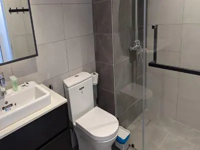 a bathroom with a shower and a toilet and a sink at Axon Residence Kuala Lumpur Pavilion in Kuala Lumpur