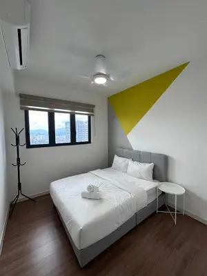 a bedroom with a large bed with a colorful wall at M Vertica KL City in Kuala Lumpur