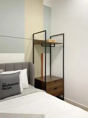 a bedroom with a bed and a wooden night stand at M Vertica KL City in Kuala Lumpur