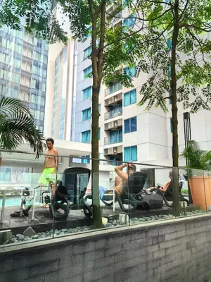 a group of people sitting in chairs in front of a building at Summer Suites KLCC By Palace in Kuala Lumpur