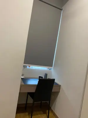 a desk with a chair in front of a wall at Infinite Pool! Room in Kuala Lumpur in Kuala Lumpur