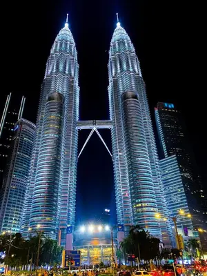 two tall skyscrapers in a city at night at Infinite Pool! Room in Kuala Lumpur in Kuala Lumpur