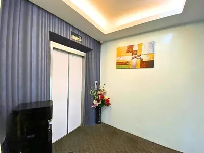 a hallway with a door and a vase of flowers at Seeds Hotel Setia Wangsa in Kuala Lumpur