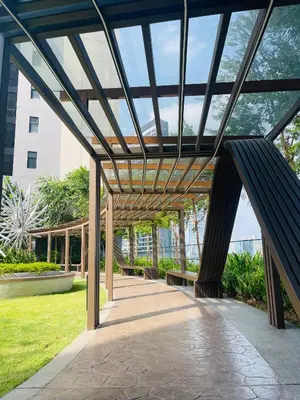a wooden pergola with benches in a park at Axon Infinity Pool KL in Kuala Lumpur