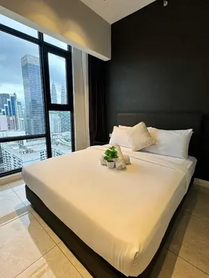 a bedroom with a large white bed with a large window at Axon Infinity Pool KL in Kuala Lumpur