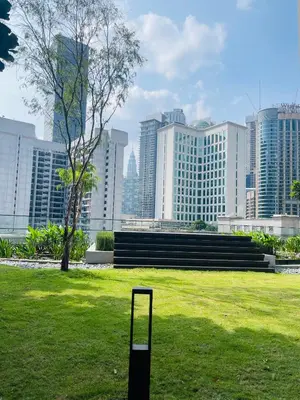 a golf club in a field with a city skyline at Axon Infinity Pool KL in Kuala Lumpur