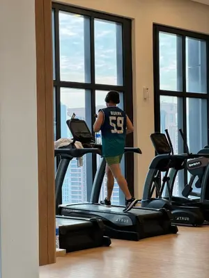 a man walking on a treadmill in a gym at Springtime 2bedrooms with KLCC view &Gorgeous pool in Kuala Lumpur