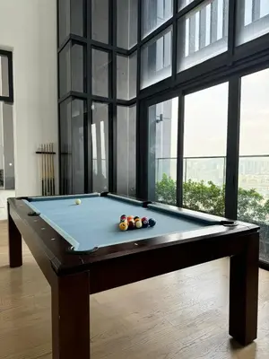 a pool table in a room with windows at Springtime 2bedrooms with KLCC view &Gorgeous pool in Kuala Lumpur