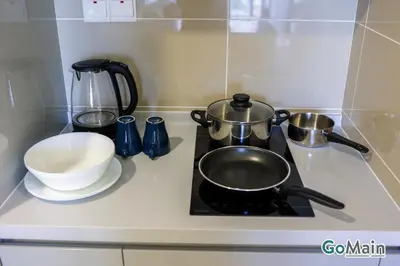 a stove top with two pots and a bowl on it at Free Parking - Big Suite Trion Kuala Lumpur by GoMain in Kuala Lumpur