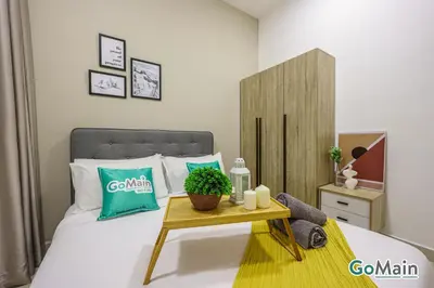 a bedroom with a bed and a table with a plant on it at Free Parking - Big Suite Trion Kuala Lumpur by GoMain in Kuala Lumpur