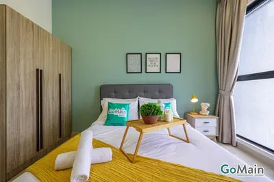 a bedroom with a bed with a table and a window at Free Parking - Big Suite Trion Kuala Lumpur by GoMain in Kuala Lumpur