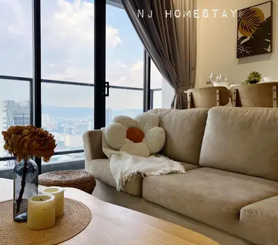 a living room with a couch and large windows at NJ Homestay AT TRION, KL in Kuala Lumpur
