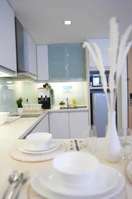 a kitchen with white plates and utensils on a counter at Studio, 6 Pax, 3mins to KLCC (3A01_2) in Kuala Lumpur